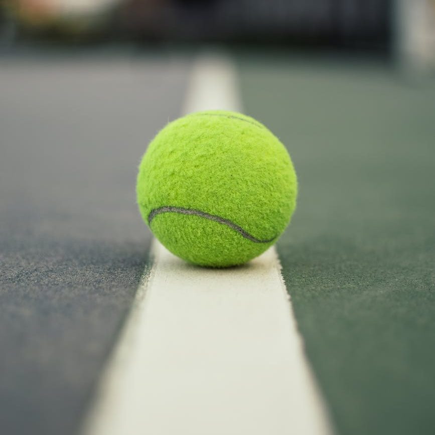 green tennis ball on court